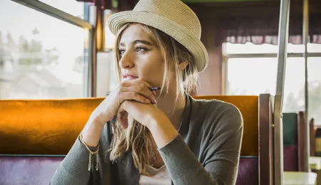 young woman with blonde hair wearing a hat