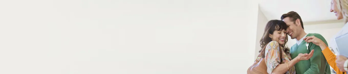 Young couple getting keys to first home