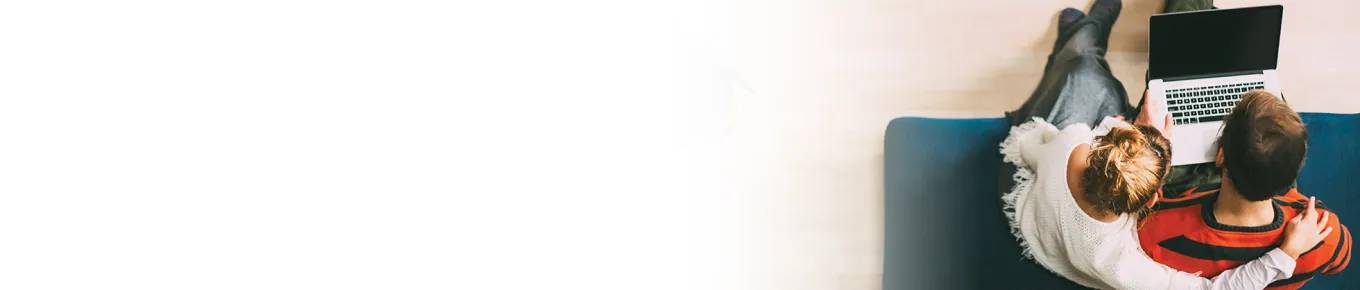 aerial view of woman and man around a laptop