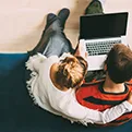aerial view of woman and man around a laptop