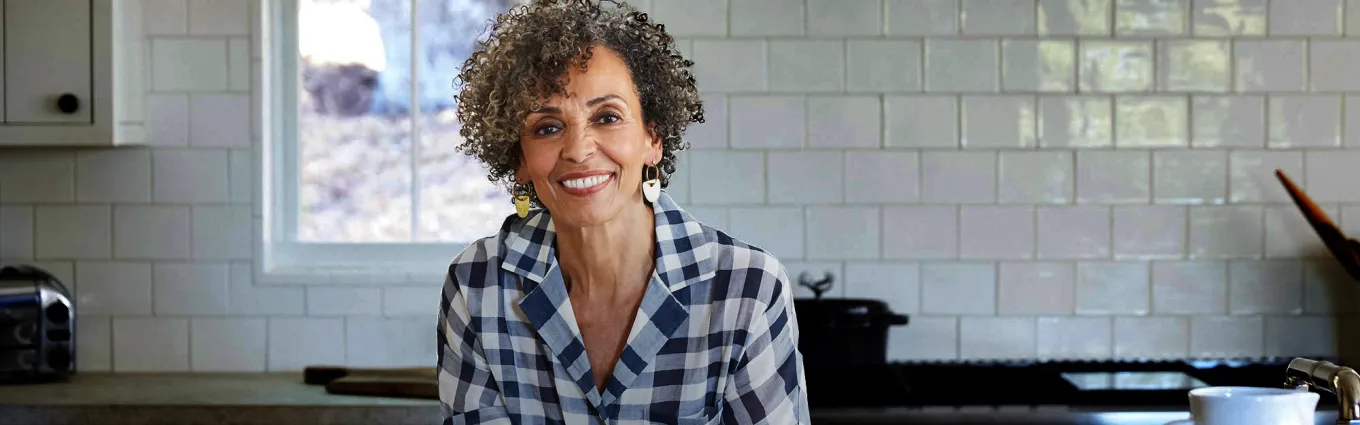 Older lady smiling in a kitchen