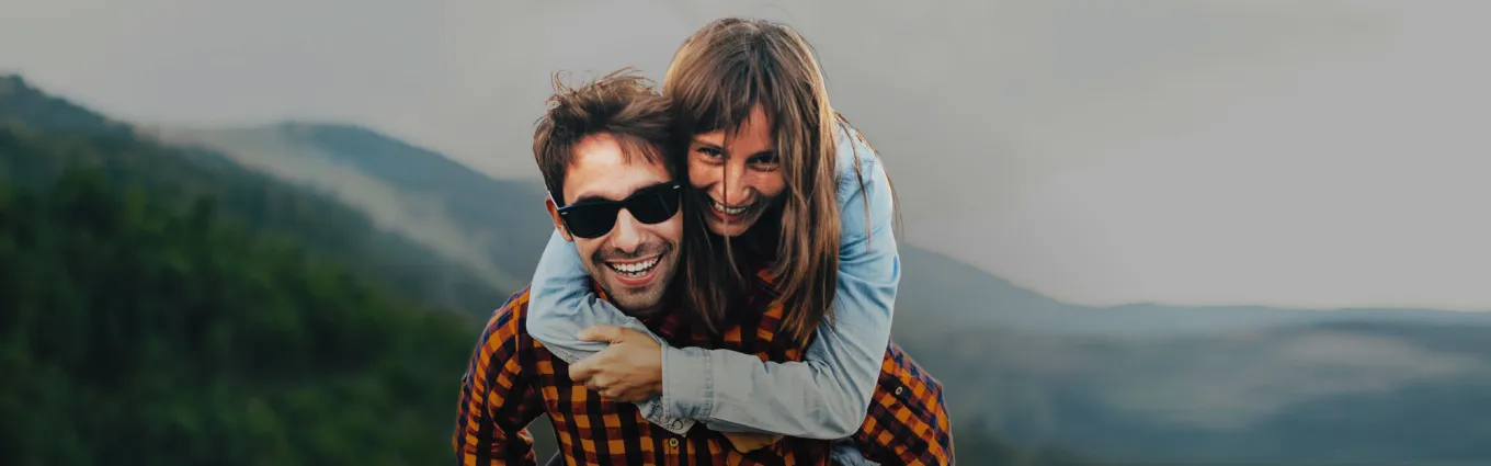 couple hugging in front of a mountain