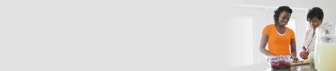 mother and daughter cutting food