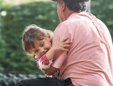 older man holding little girl