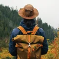 man wearing backpack and hat