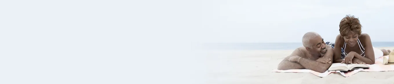 african american couple laying on the beach