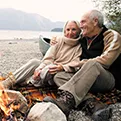 older couple sitting on a beach