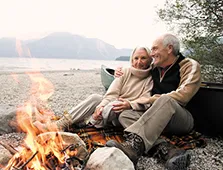older couple sitting on a beach